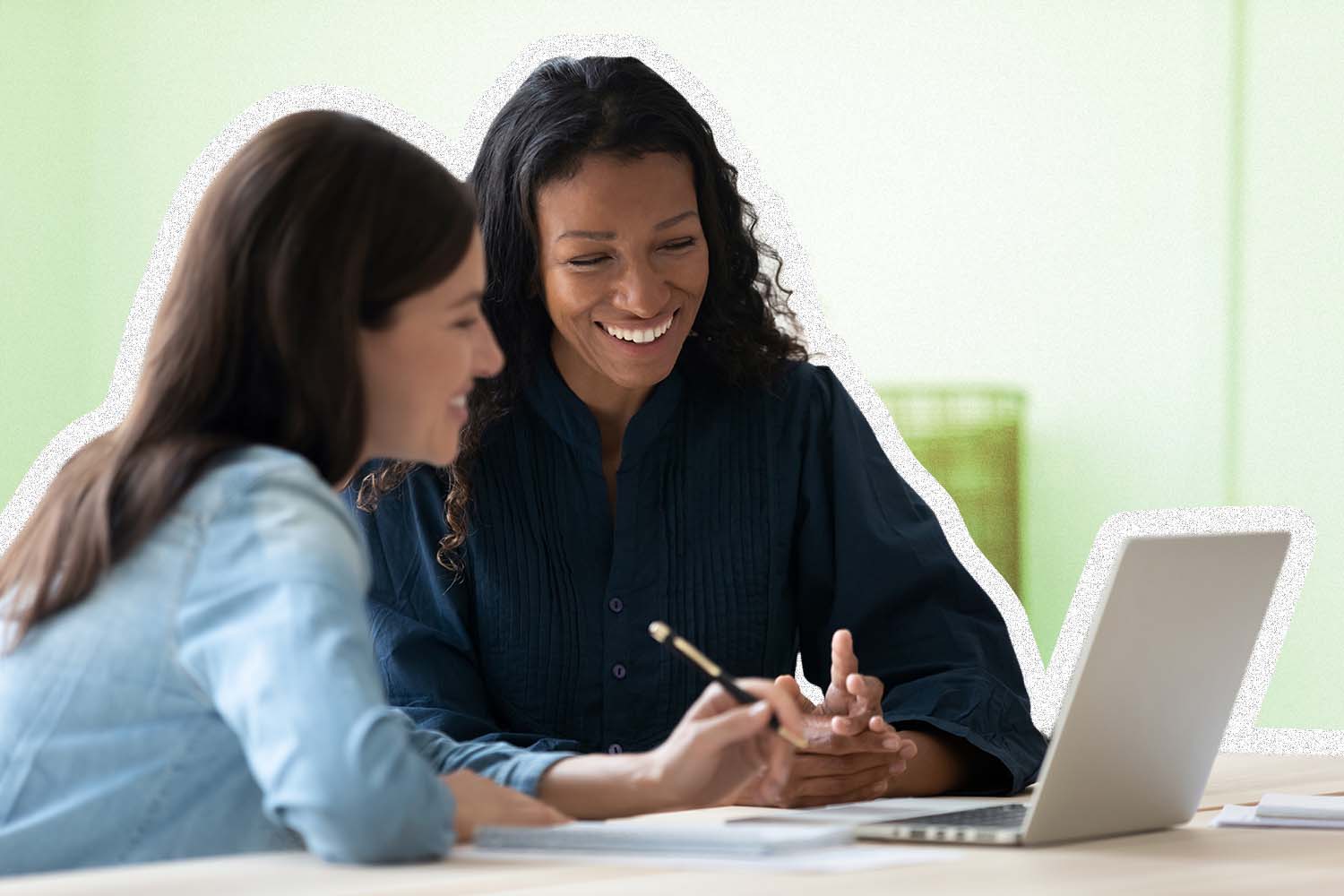 Two women work at a computer