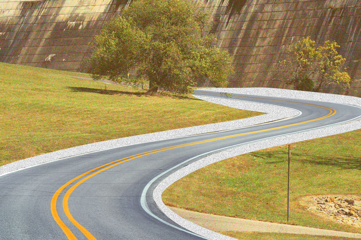 road curving through a grassy area