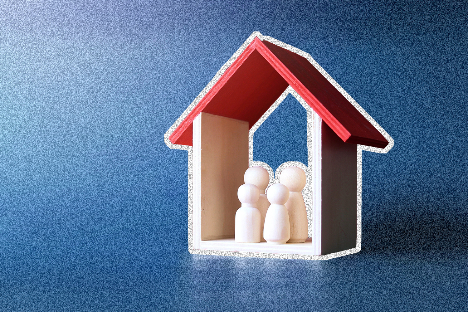 A wooden frame of a house with four wooden people shapes inside