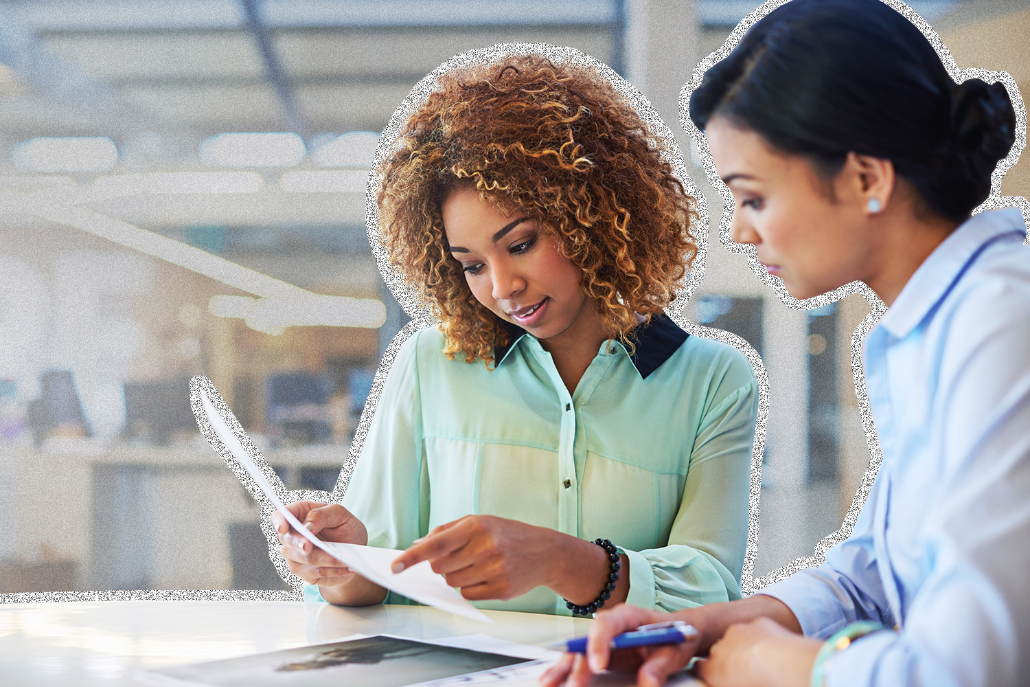 Two women reviewing a printed document together