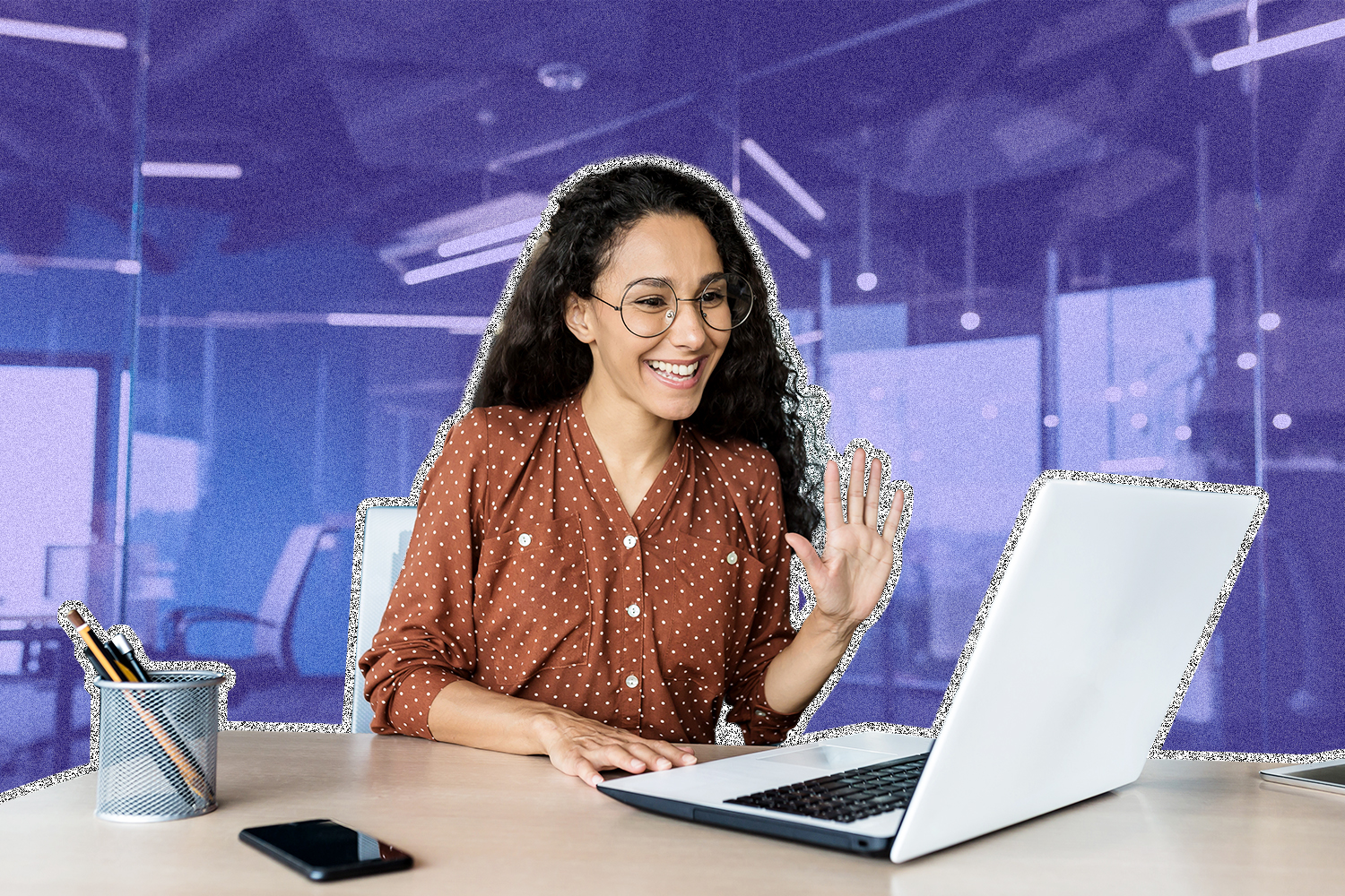 A woman waving to her laptop screen while on a video conference call