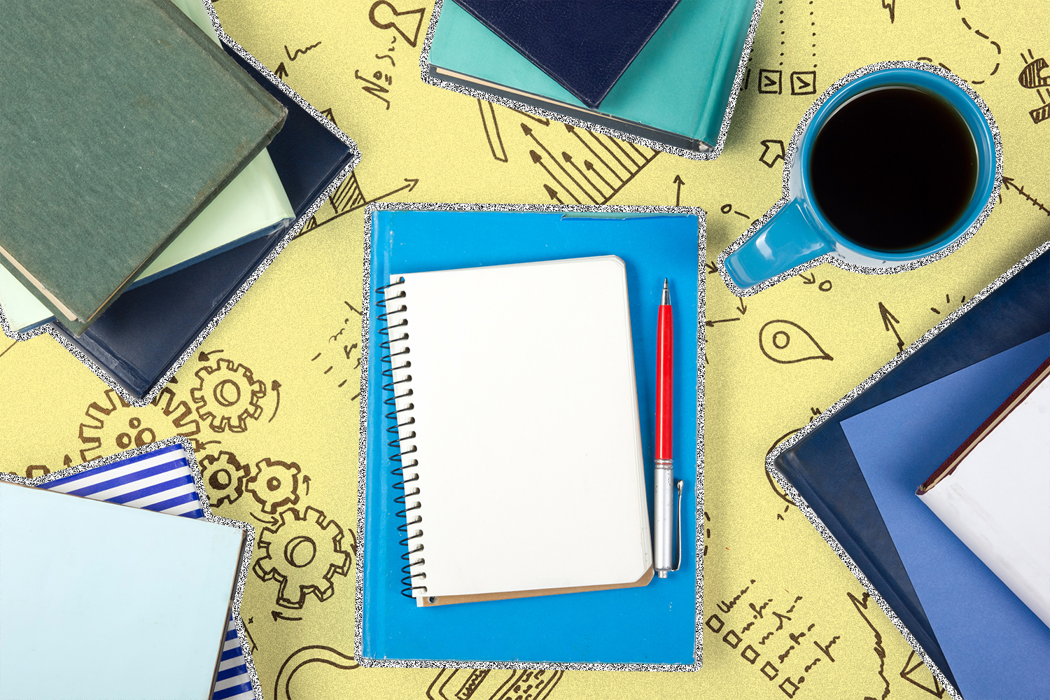 Five stacks of blue and green notebooks and a blue coffee mug on top of a yellow table with drawings on it