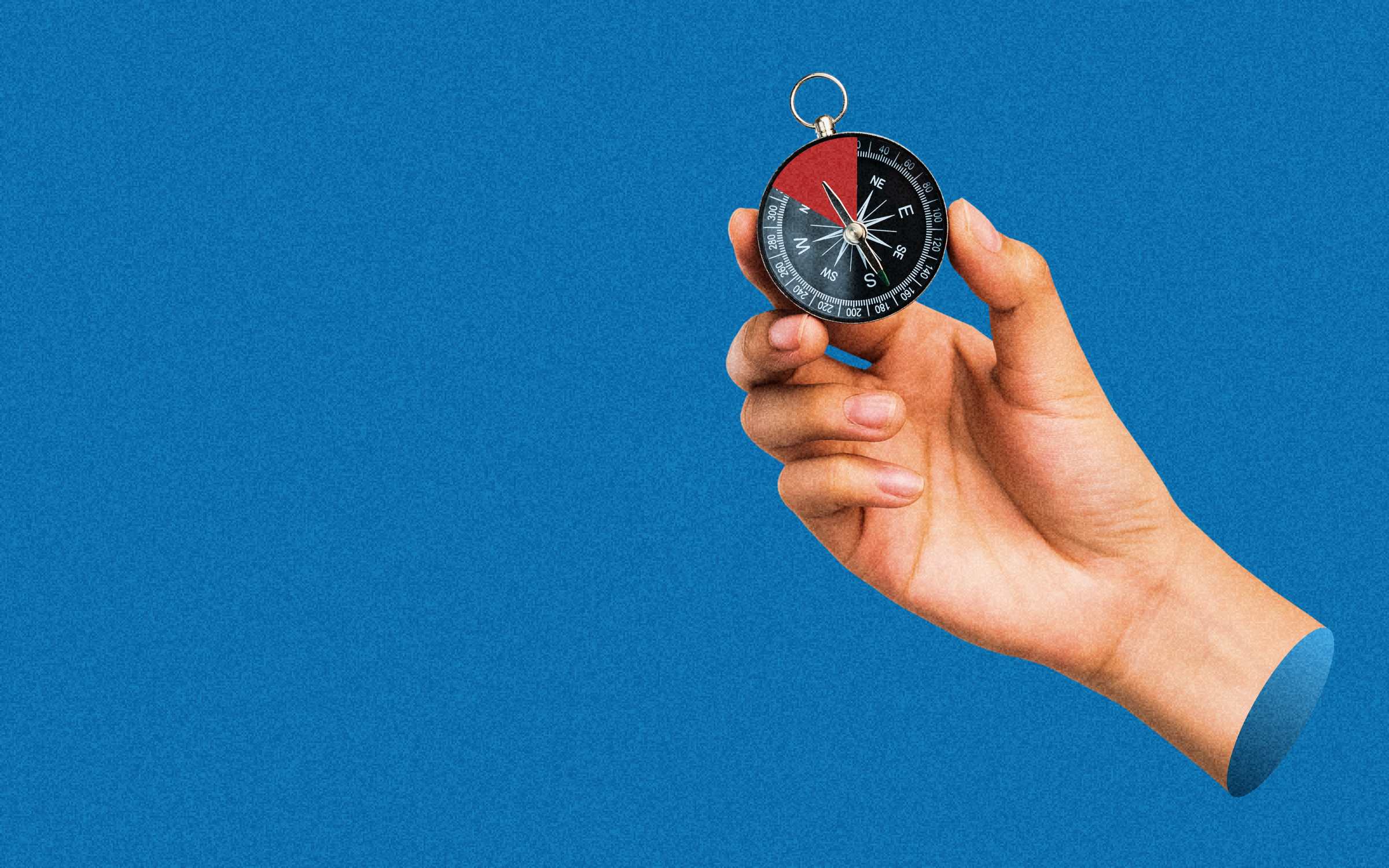 A hand holding a compass against a blue background, symbolizing direction, decision-making, and navigating complex challenges.