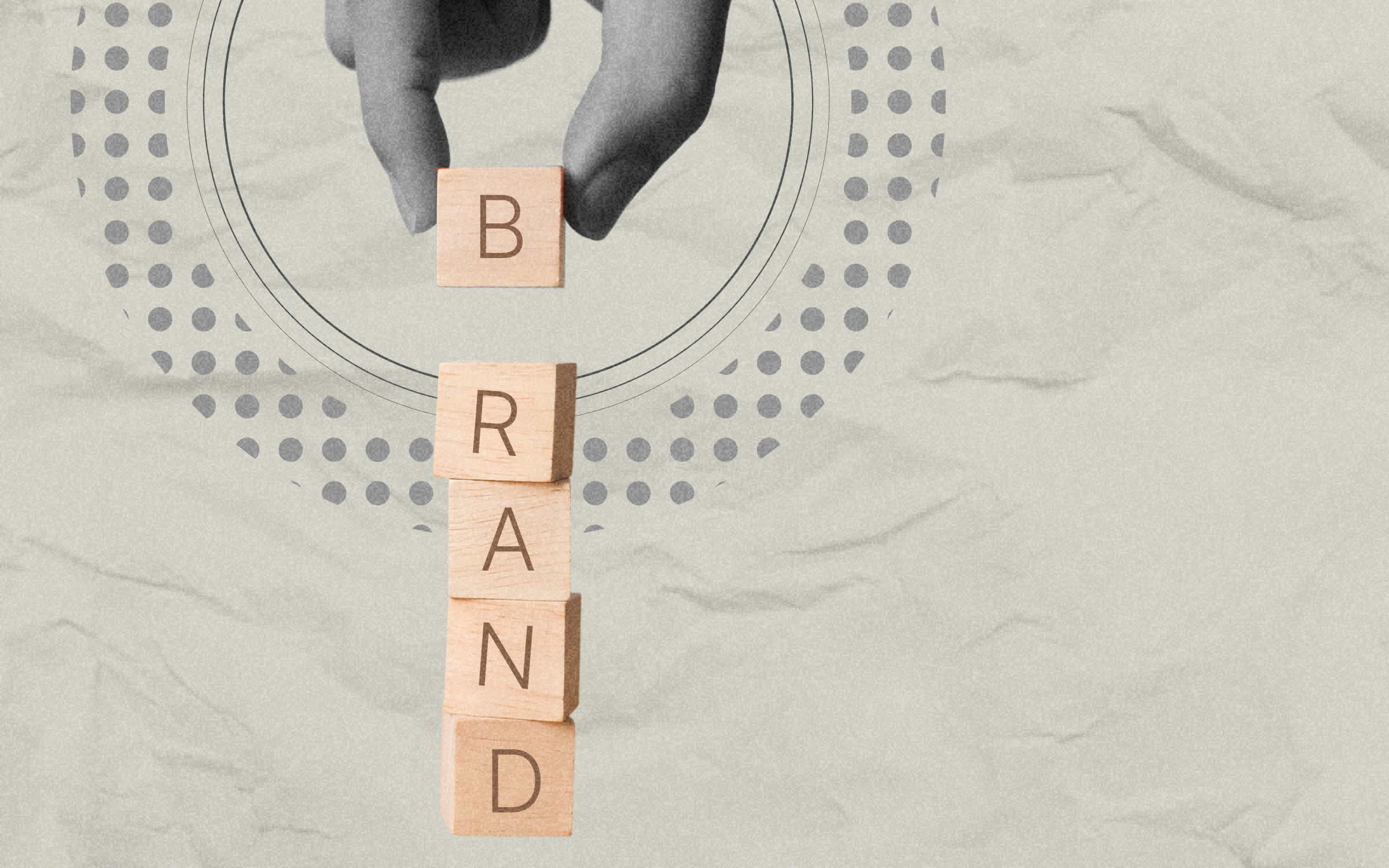 A hand places a wooden block labeled “B” on top of stacked blocks spelling “BRAND,” symbolizing brand building, identity development, and strategic storytelling in marketing.