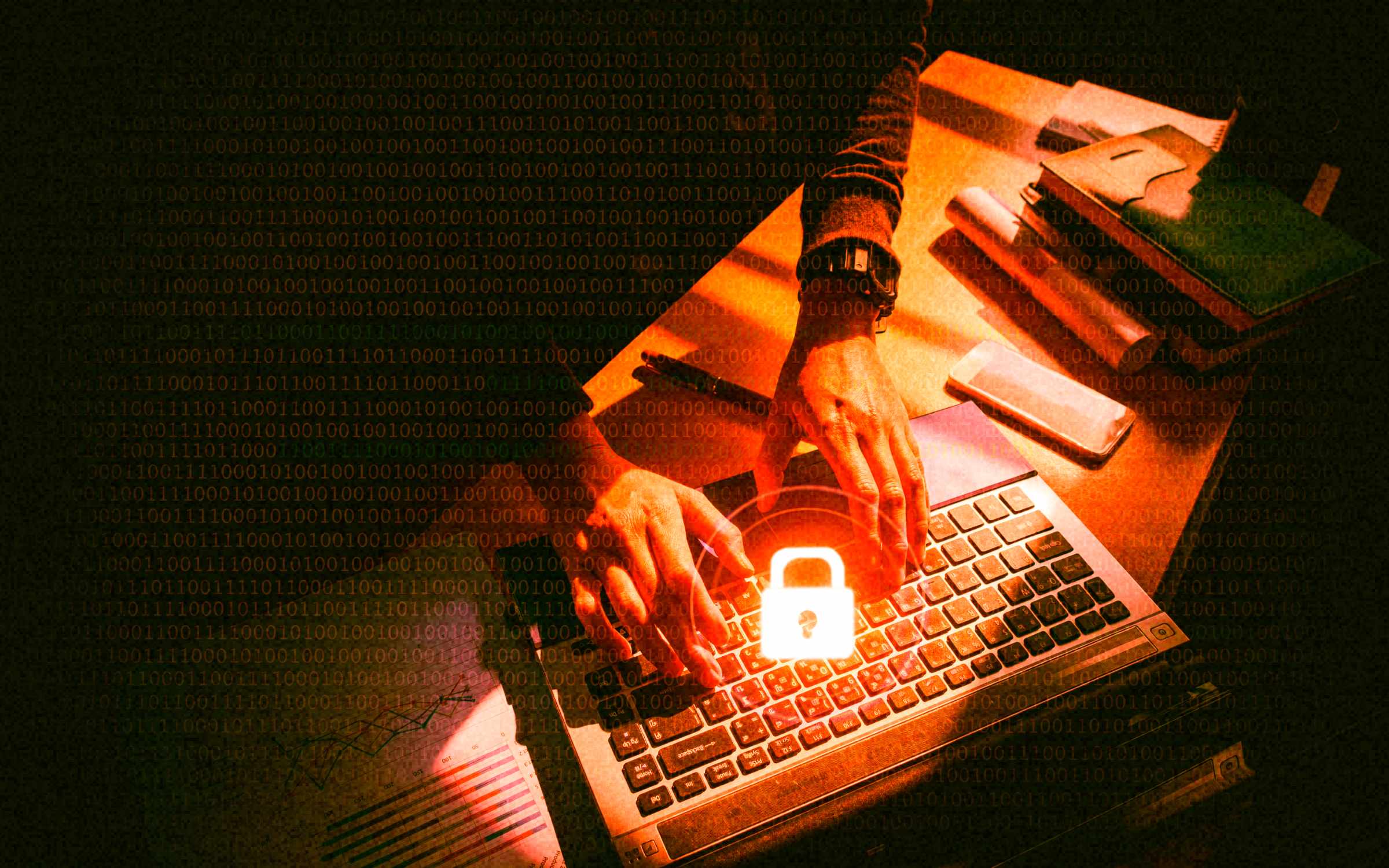 A person works on a laptop at a desk under dramatic red-orange lighting, with a glowing padlock icon over the keyboard symbolizing cybersecurity protection. A smartphone, notebook and papers sit nearby, while lines of binary code overlay the image to represent digital data, cyber risk and secure remote work environments.
