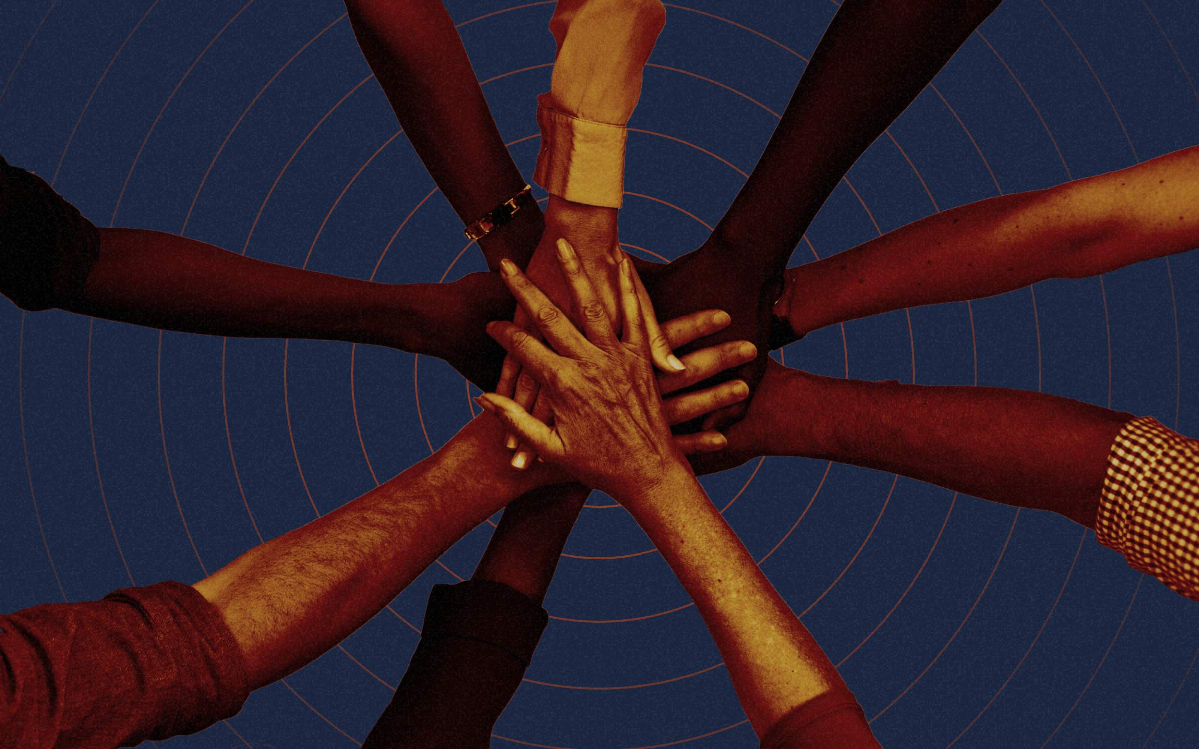 A team of hands all put in together in a signal of teamwork. The hands are of different races and ethnicities. This image conveys teamwork, communication, DEI, diversity, culture, and inclusion.
