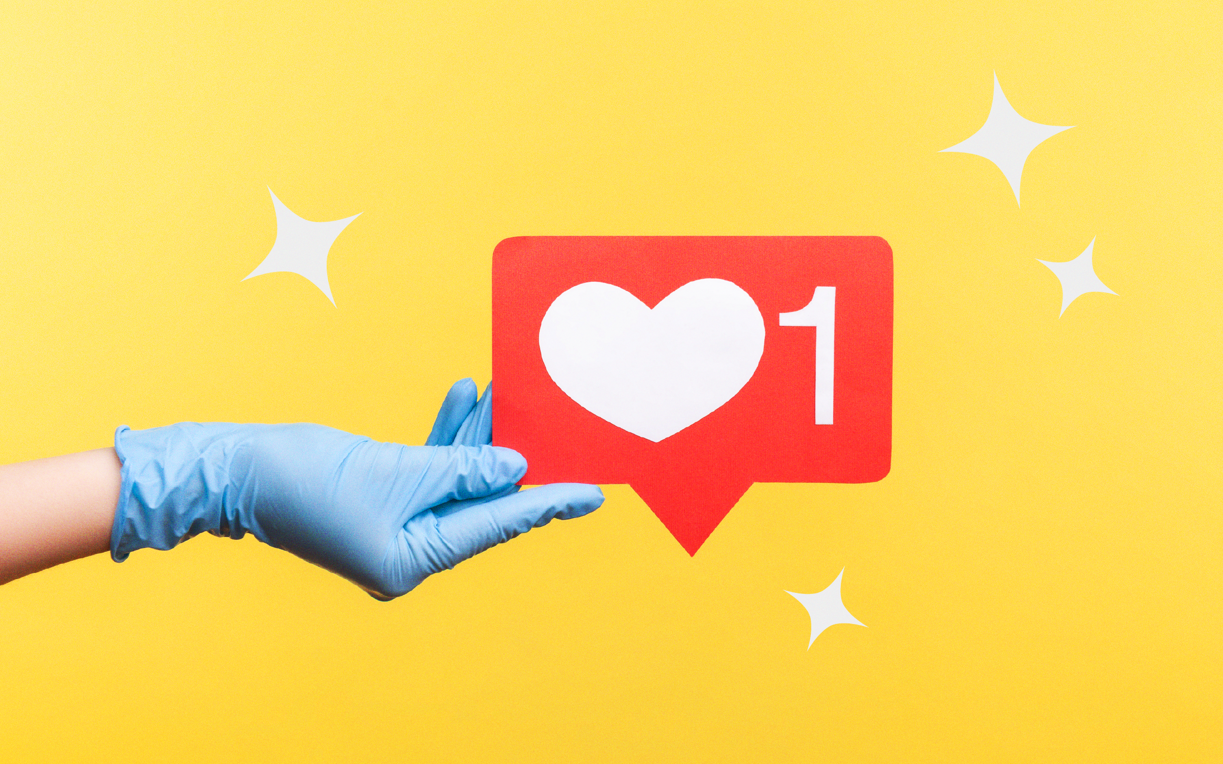 Image of a surgical-gloved hand holding the signature instagram like icon.